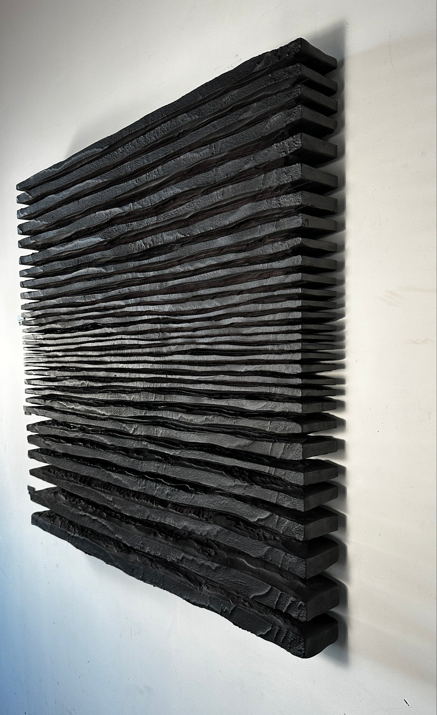Black acoustic panel on a white wall