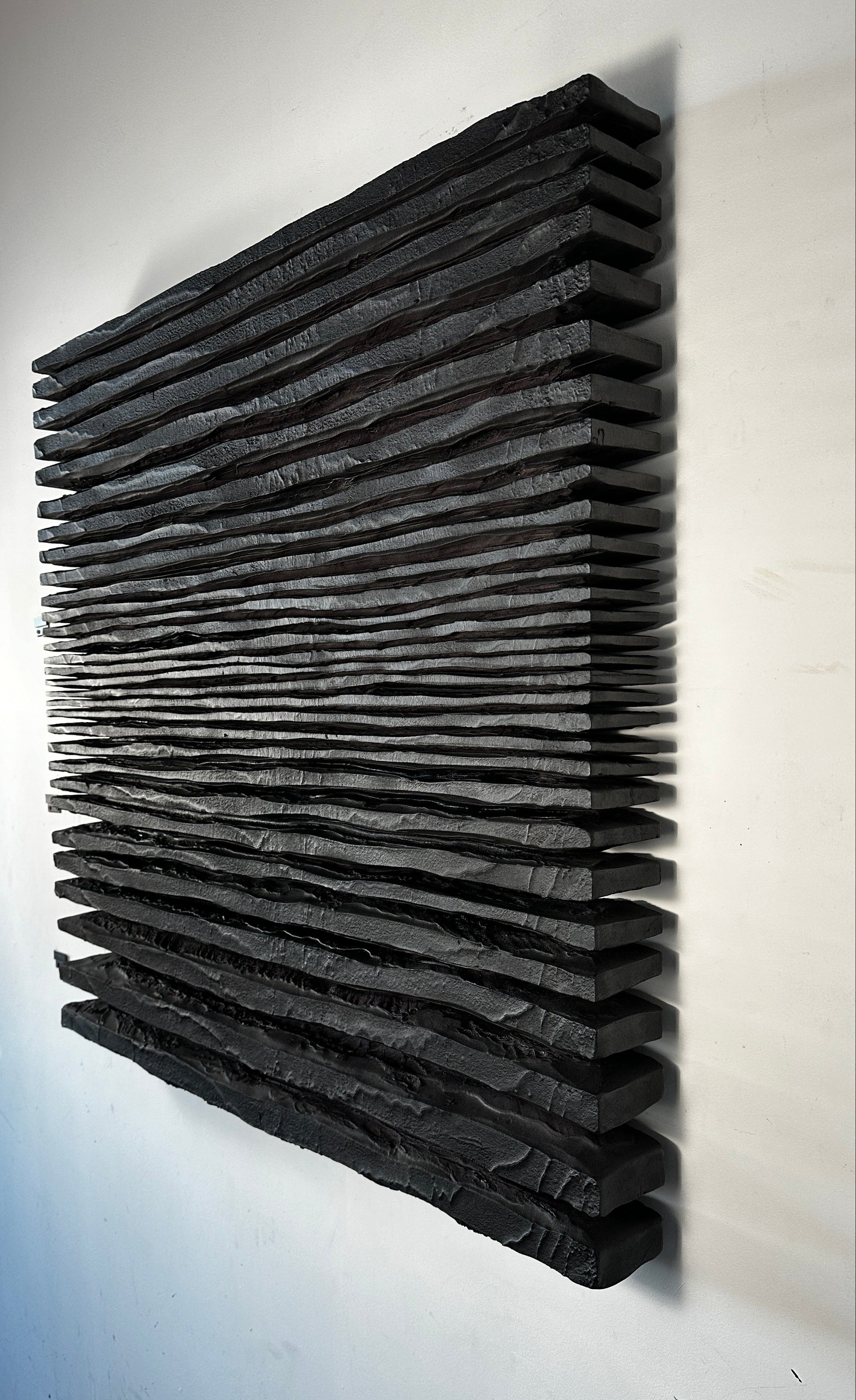 Black acoustic panel on a white wall