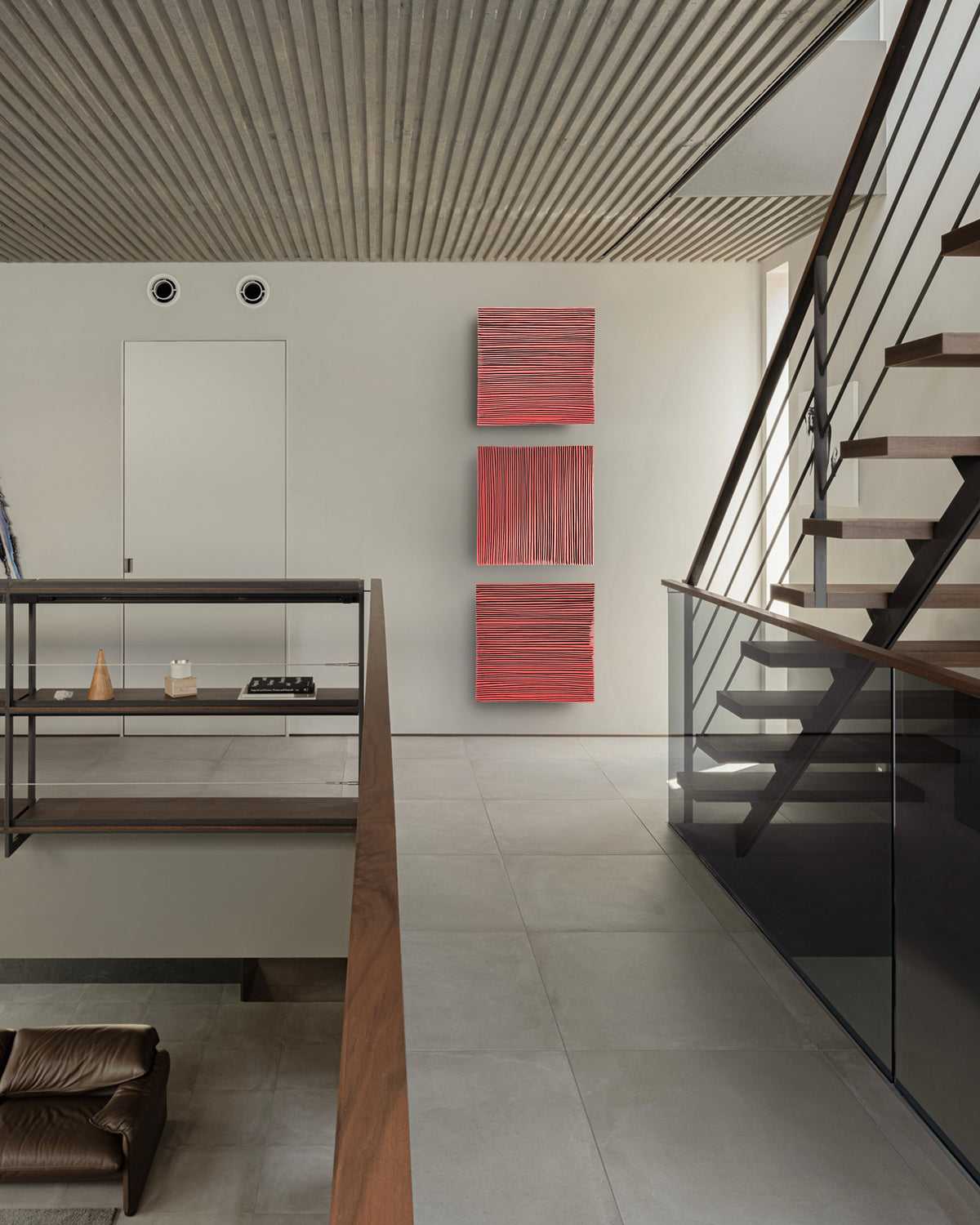 SHADOW — Crimson Study, three red panels stacked vertically beside an open staircase