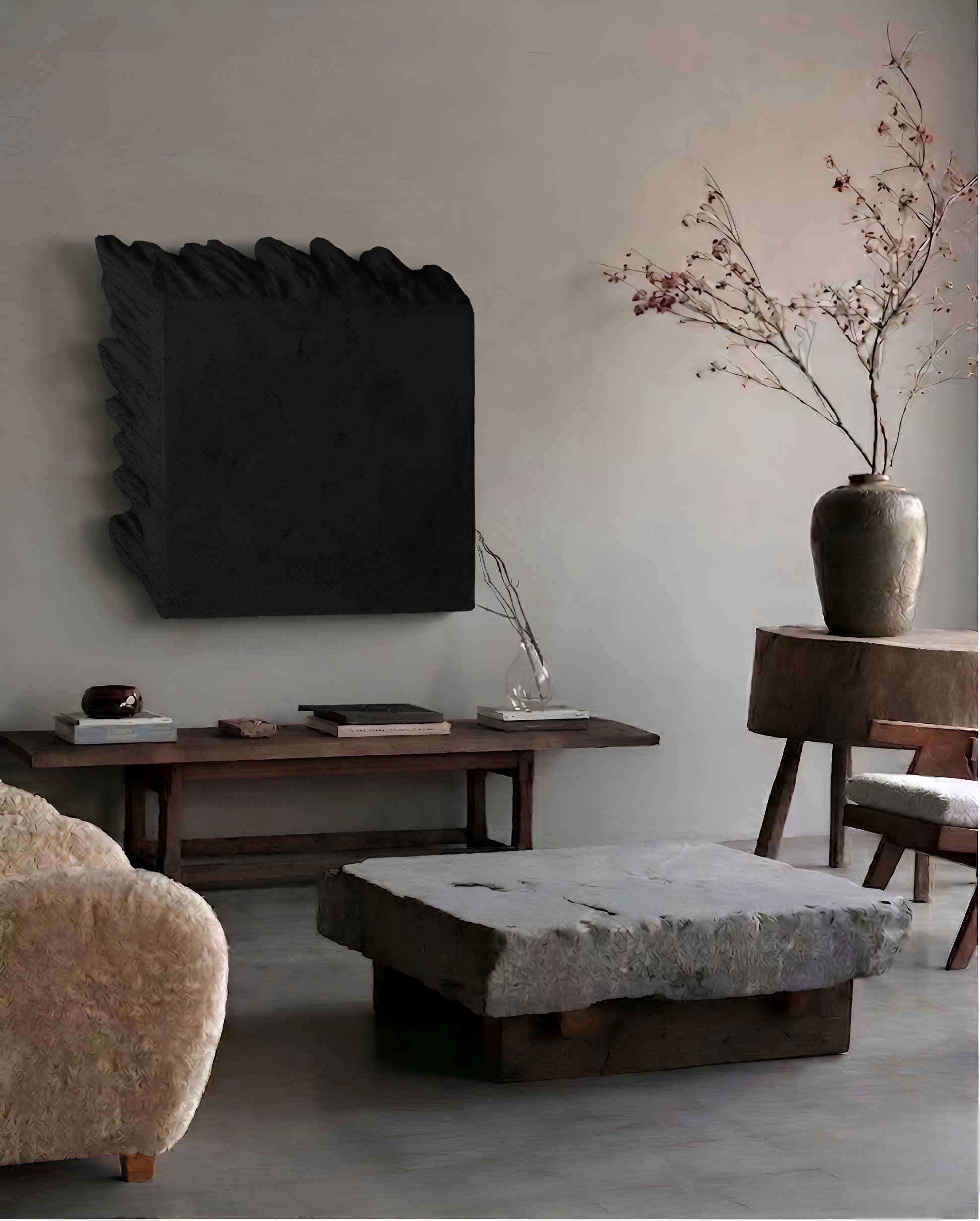 Modern living room with a textured wall, wooden coffee table, and decorative elements.