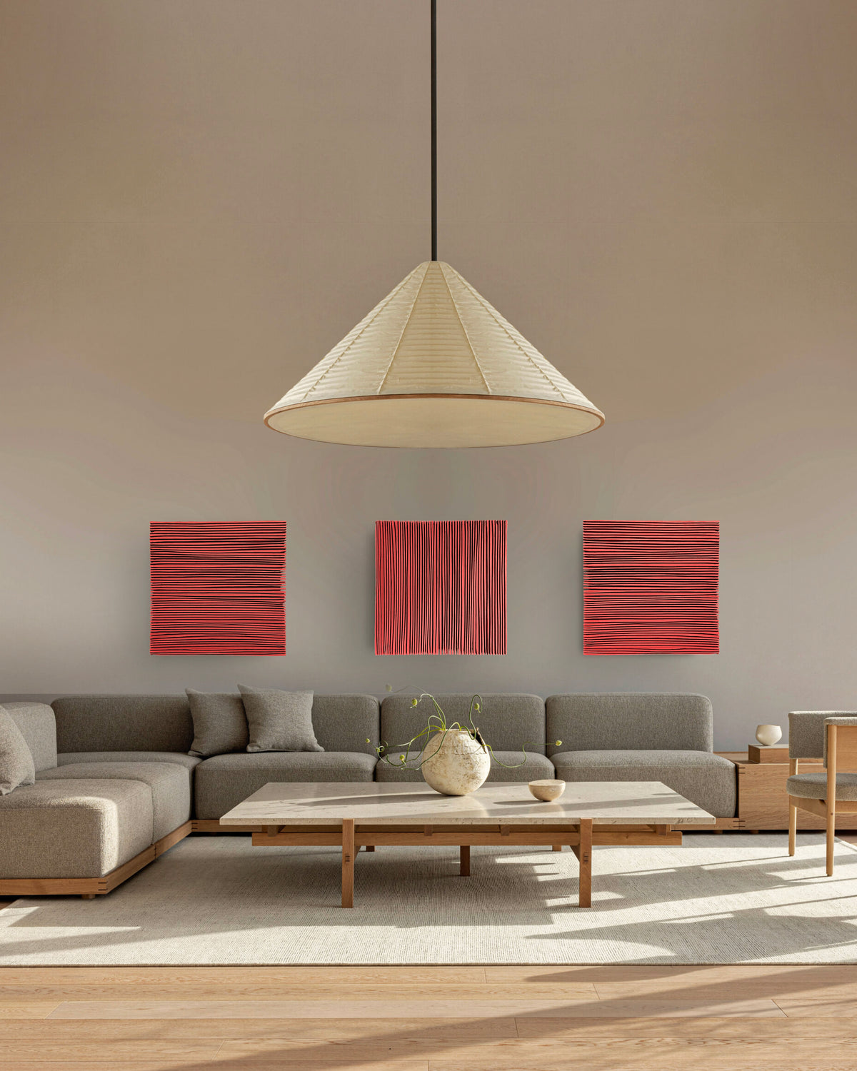 SHADOW — Crimson Study, set of three red panels above a sofa under a paper pendant lamp