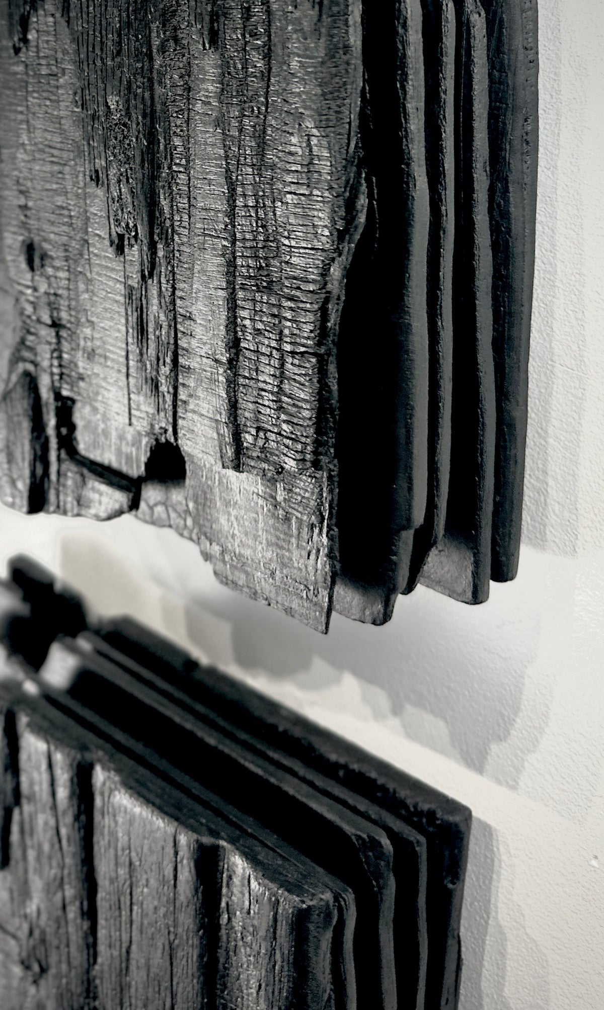 MORI — Charcoal Black, edge detail of stacked layers and burnt wood texture