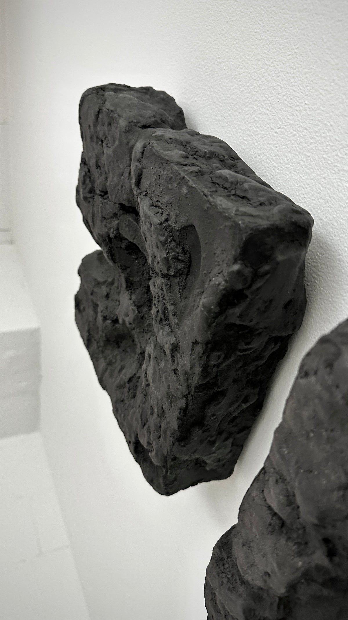 GAIA — Black Raw, studio view, natural light on raw black textured surface