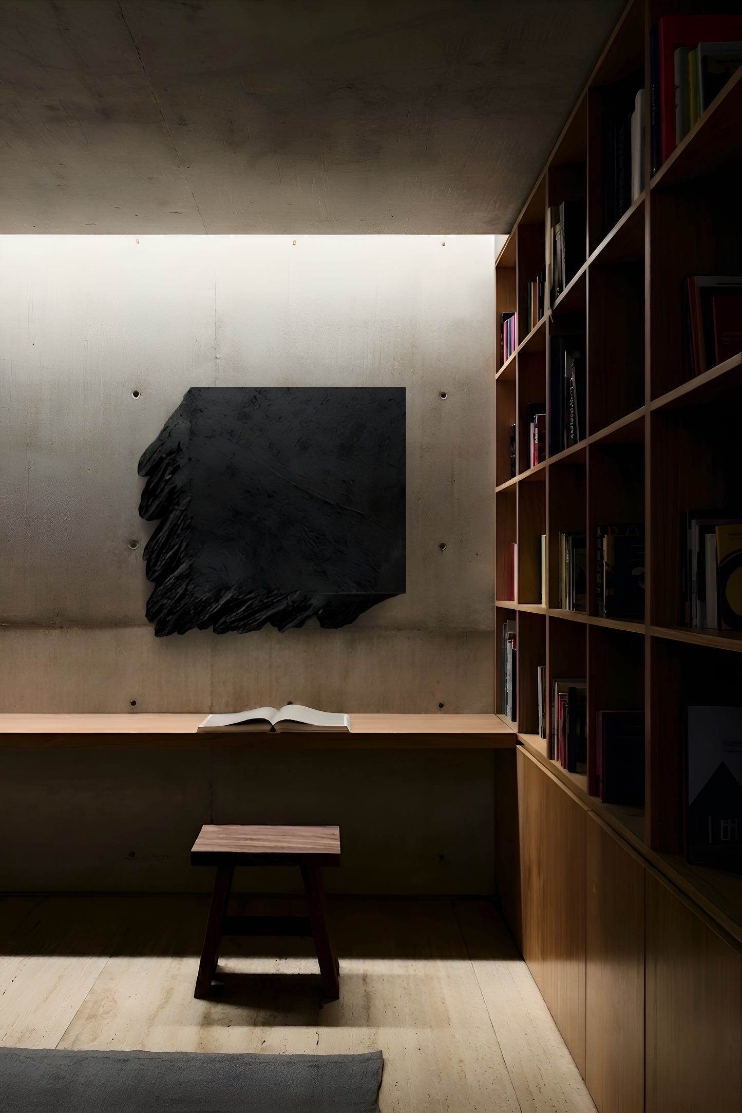 Modern interior with a black abstract sculpture on a wall, wooden bench, and bookshelf.