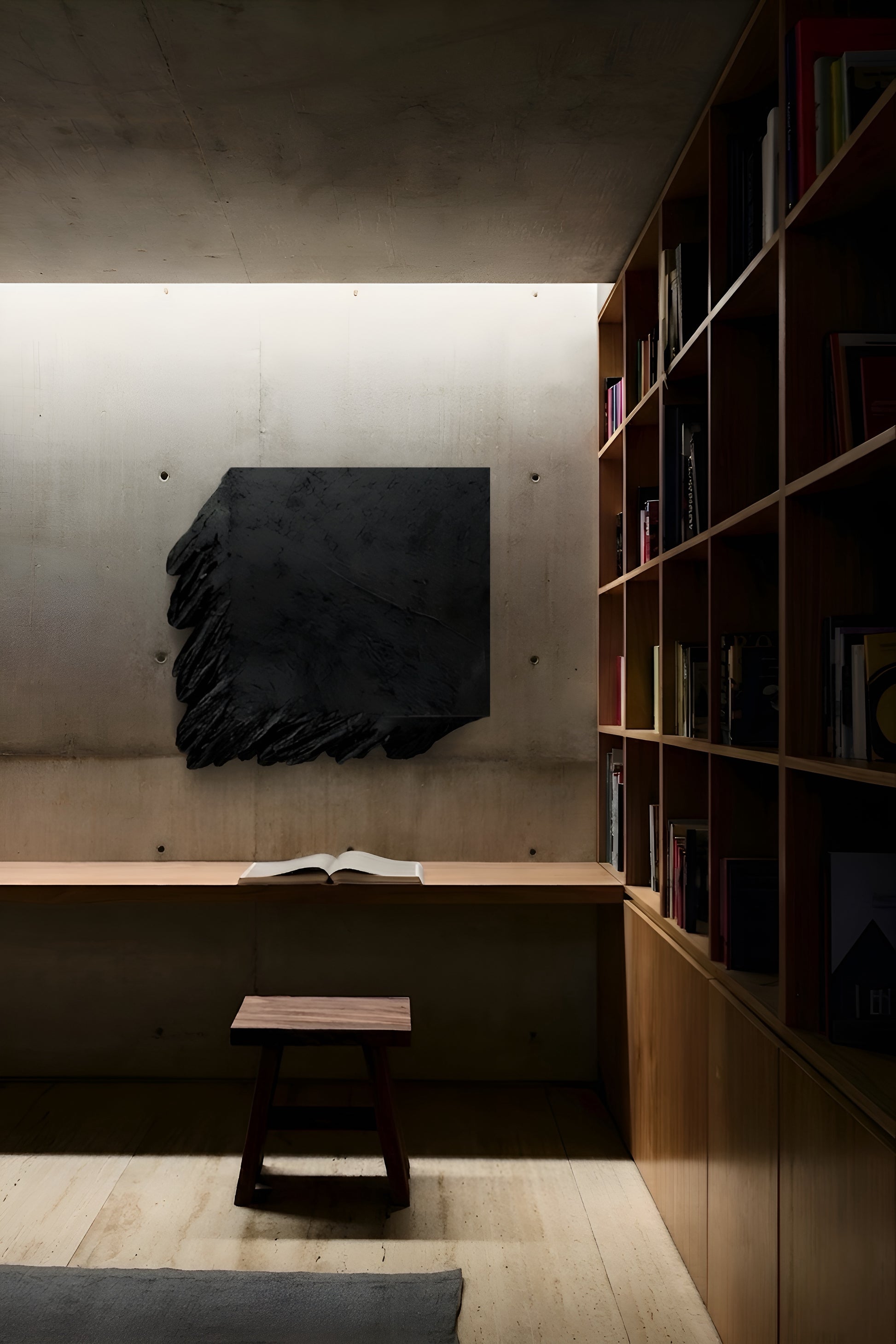 Modern interior with a black abstract sculpture on a wall, wooden bench, and bookshelf.