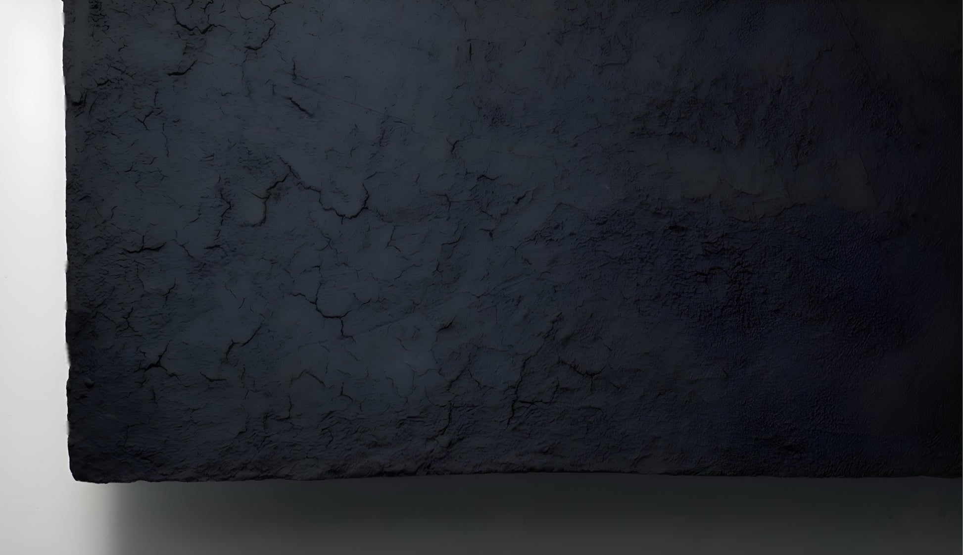 Dark gray textured rectangular stone slab on a white background