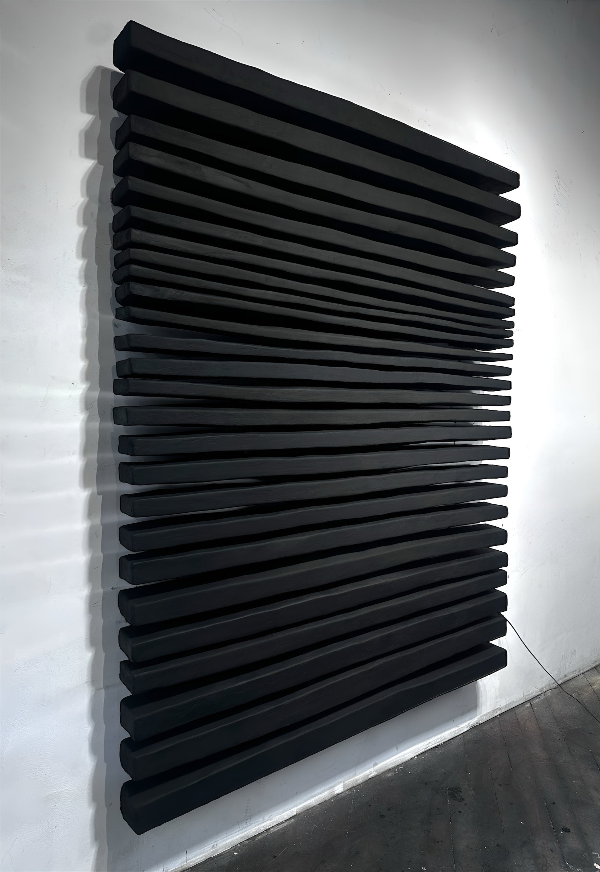 Modern black radiator against a white wall