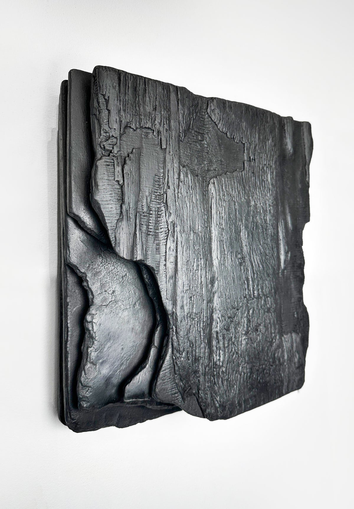 MORI — Charcoal Black, three-quarter view, deep layered relief with carved hollow edge