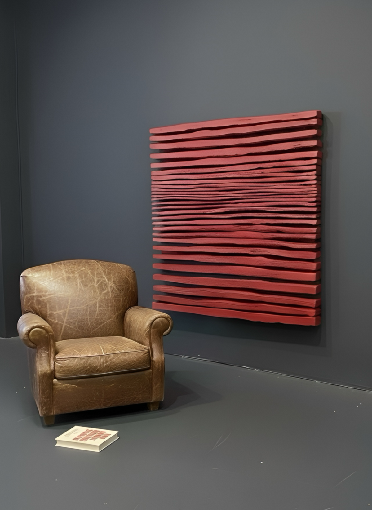 SHADOW — Crimson Study, large red ridged panel beside a leather armchair on charcoal wall