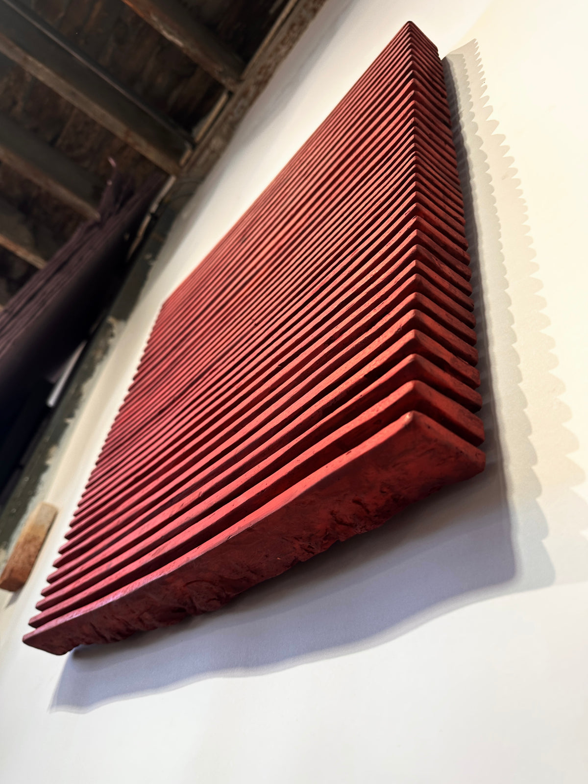 SHADOW — Crimson Study, low angle in the Brooklyn studio, ridges catching side light