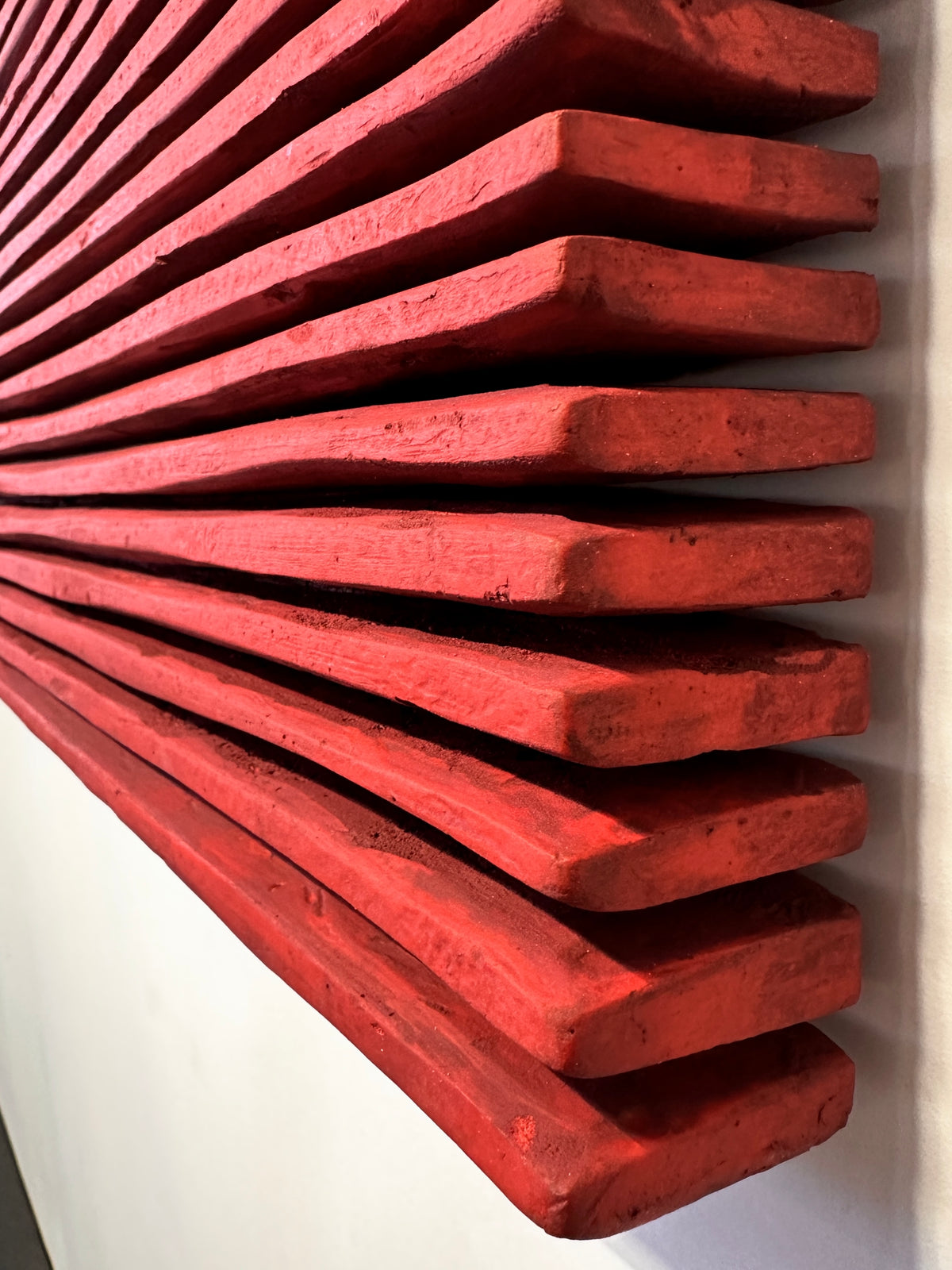 SHADOW — Crimson Study, edge detail, ridge ends fanning out from the wall, textured red plaster