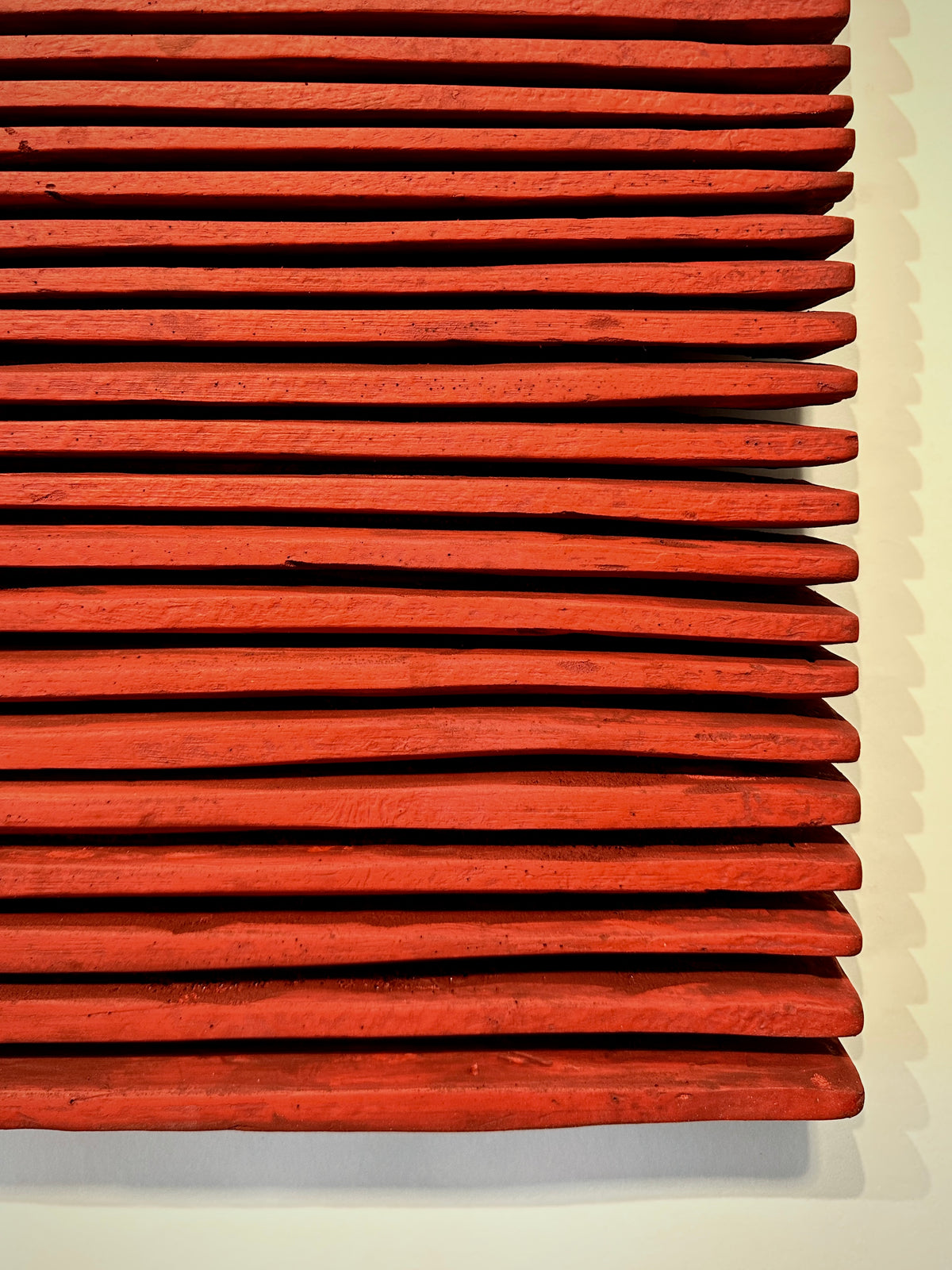 SHADOW — Crimson Study, close-up of hand-cut red ridges and deep shadow lines between them