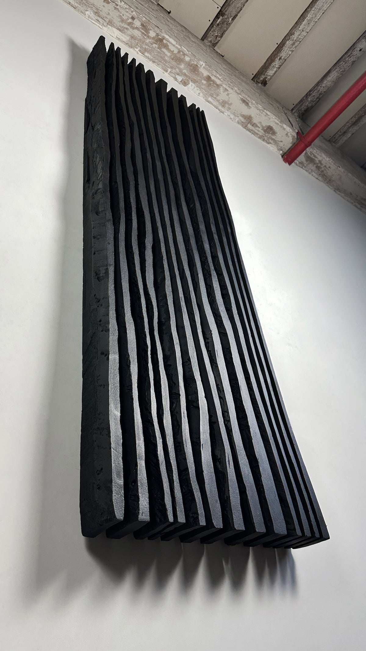 SHADOW — Noir Aurora, close-up blade detail, wavy edges casting shadows, matte black plaster