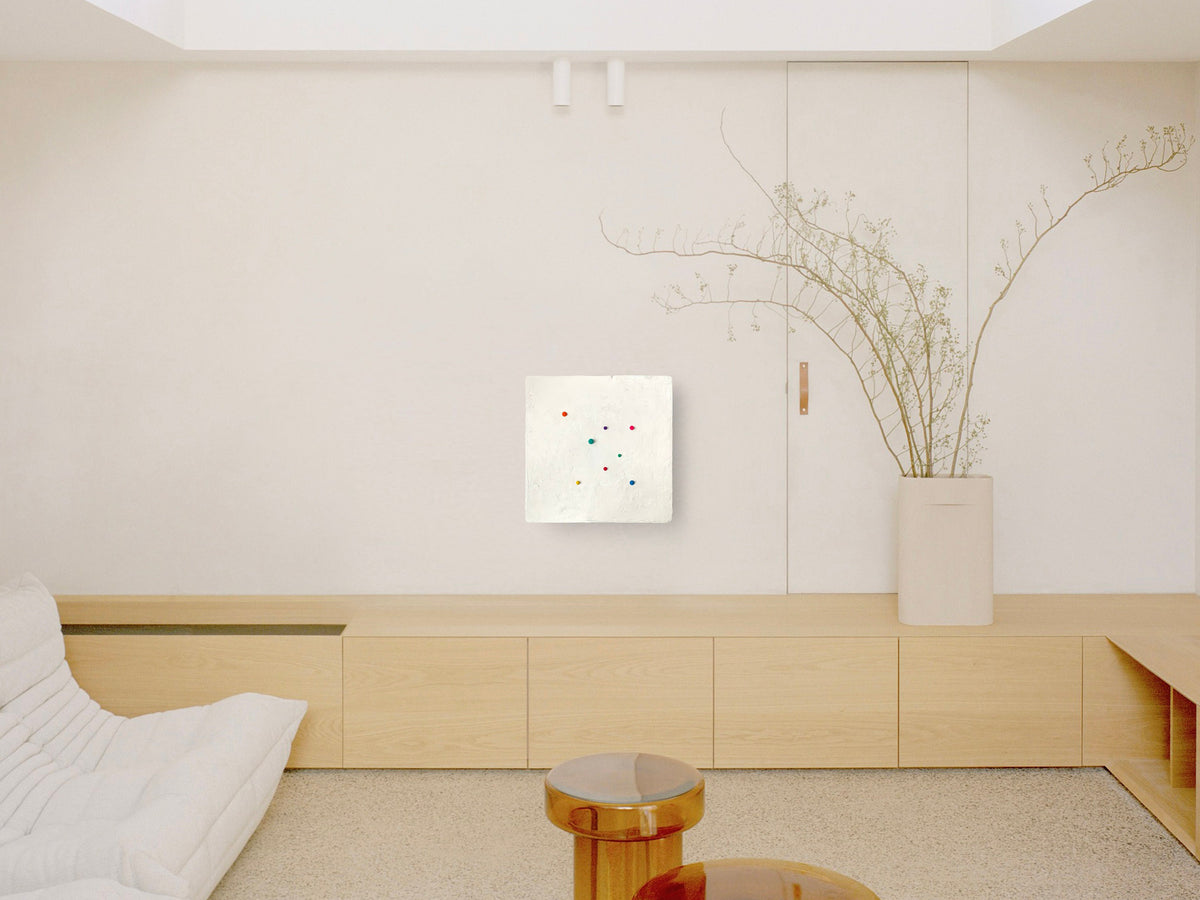 SHUN — White base, white dot panel above a light wood credenza in a calm interior