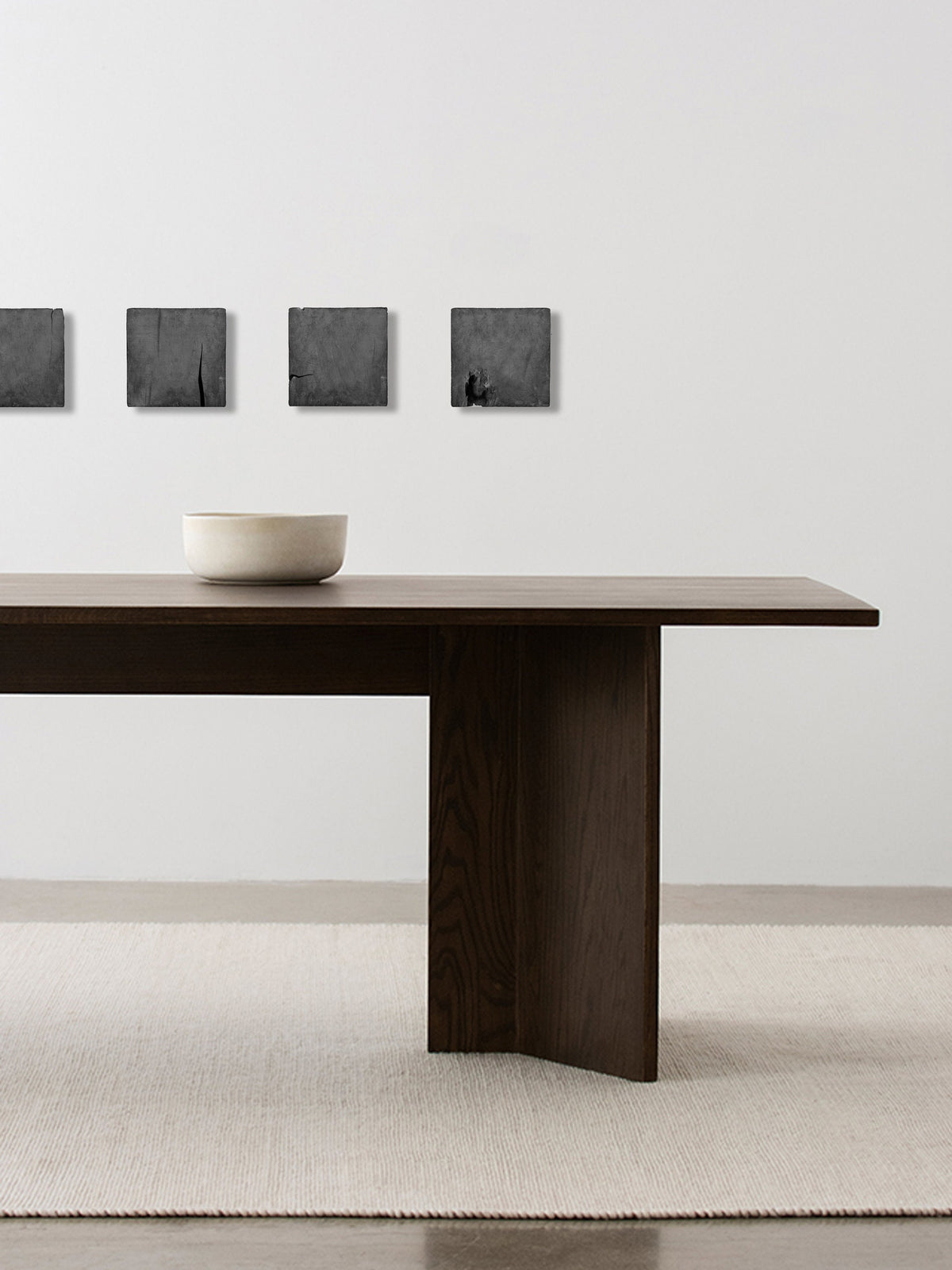 CONCRETICA — Graffiti Grey, row of panels above a dark wood dining table