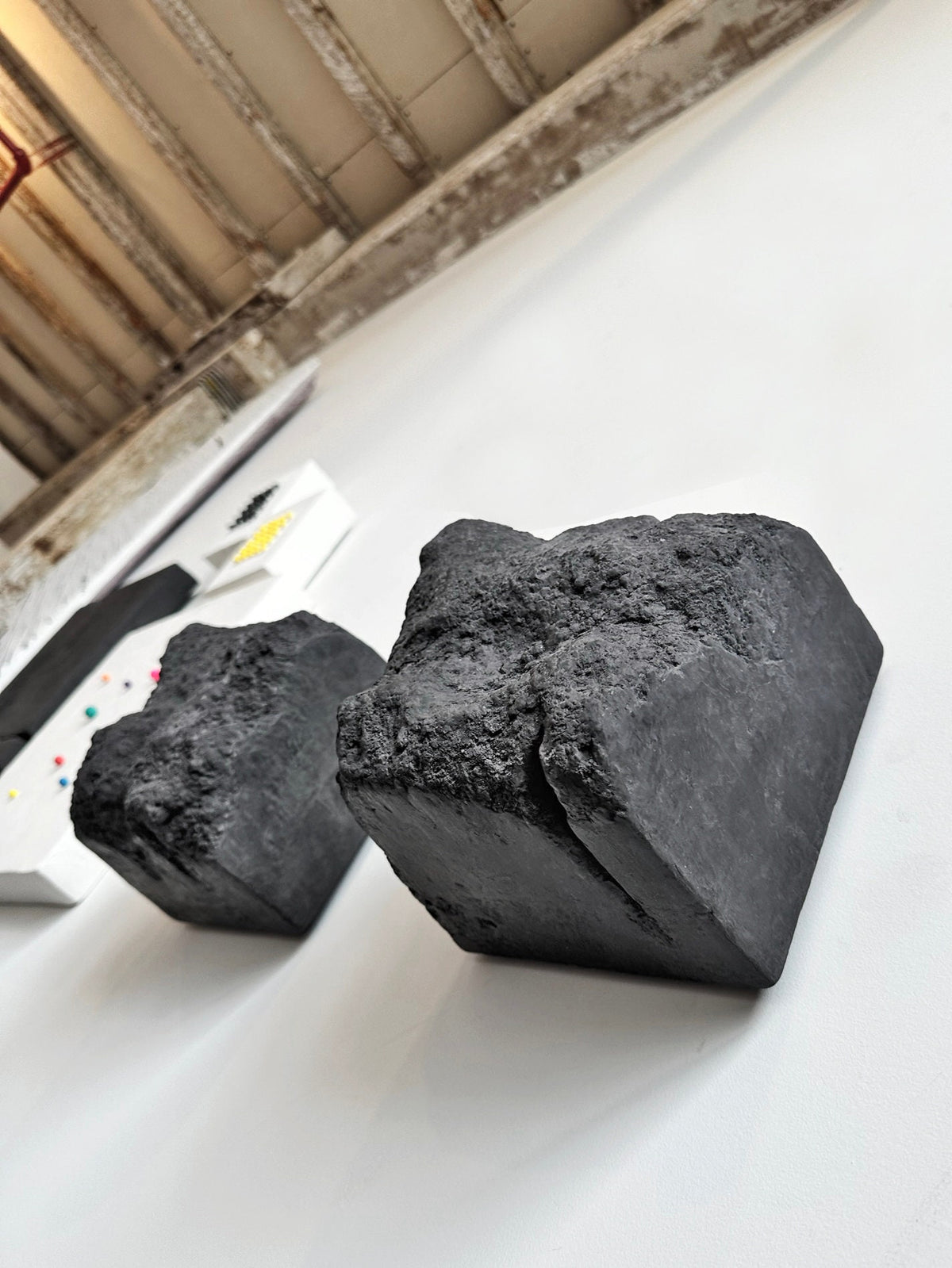 BROX — Charcoal Black, two block sculptures on white studio wall, angled view