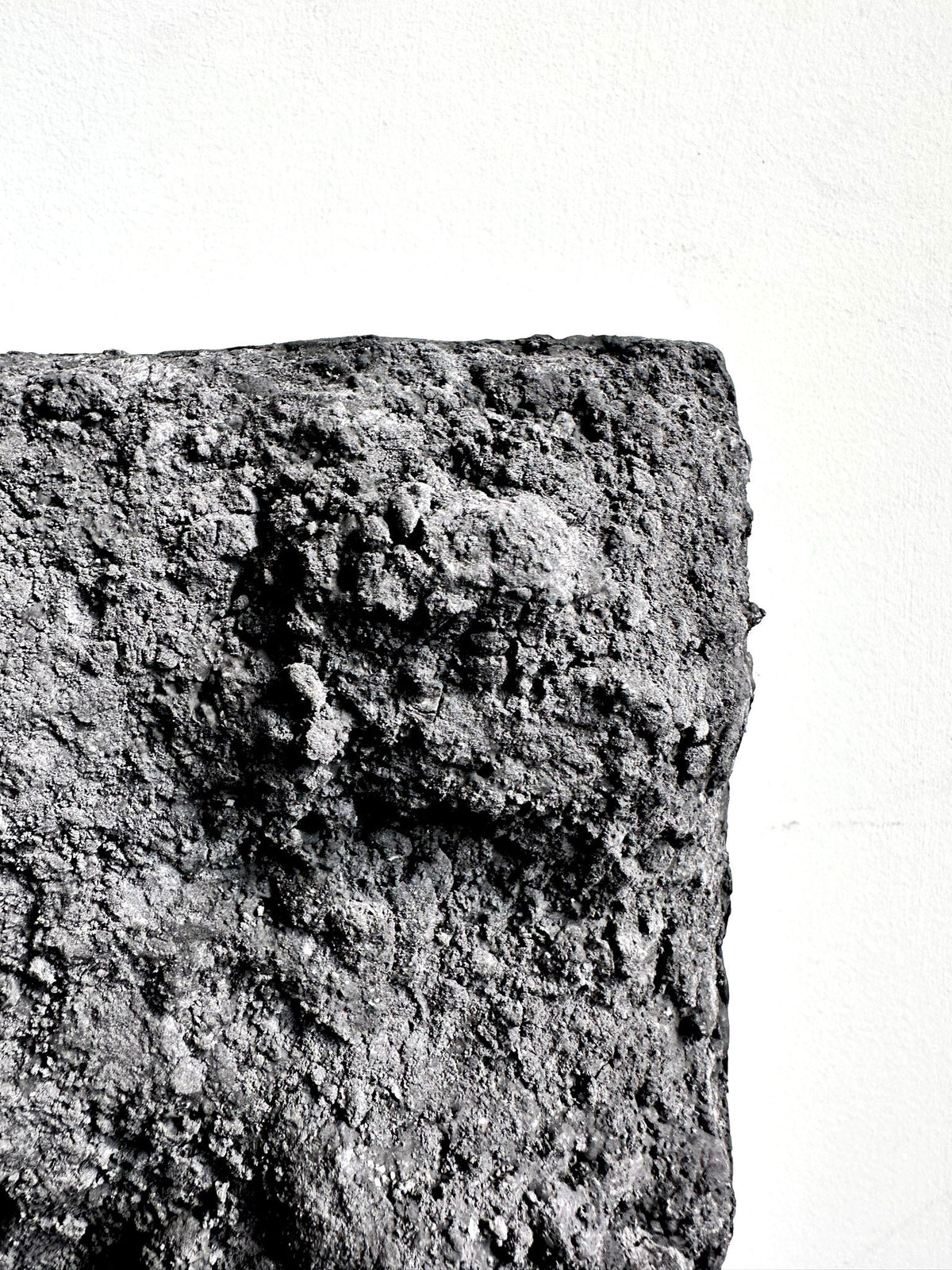 BROX — Charcoal Black, close-up of granular charcoal surface, SIZMARI