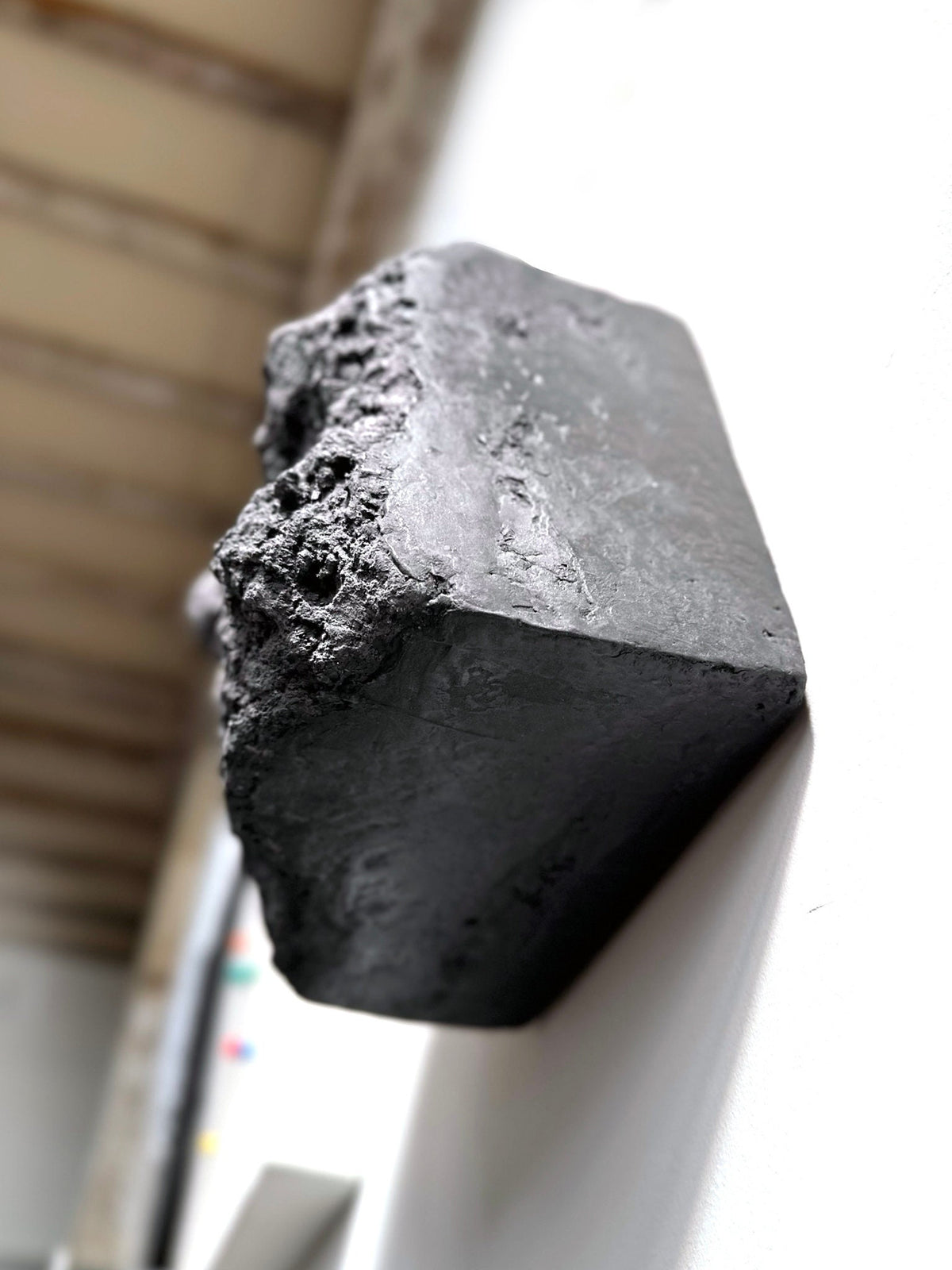 BROX — Charcoal Black, plaster block with rough broken face, side view from below