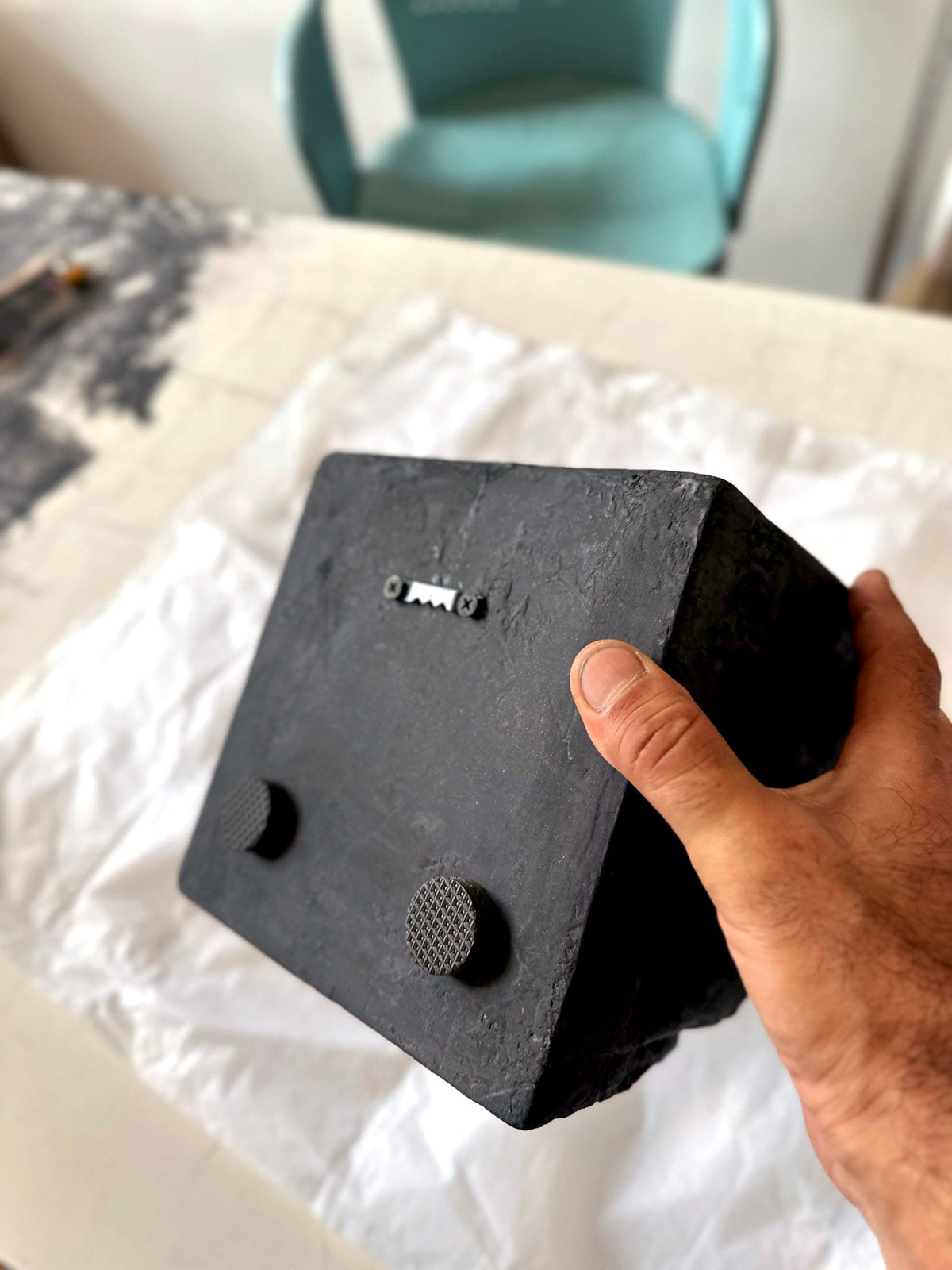 BROX — Charcoal Black, back of the block held in hand, showing hanging hardware