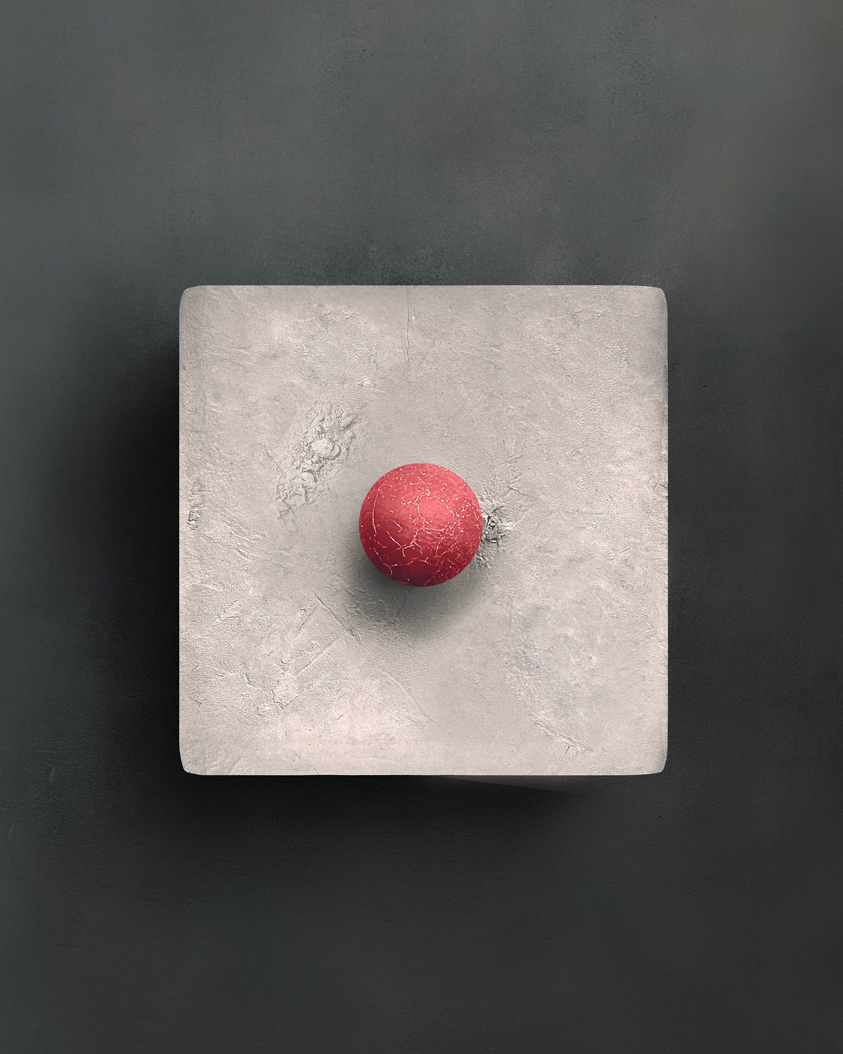 DOT — Gray with red, pale gray plaster square with red sphere, frontal view