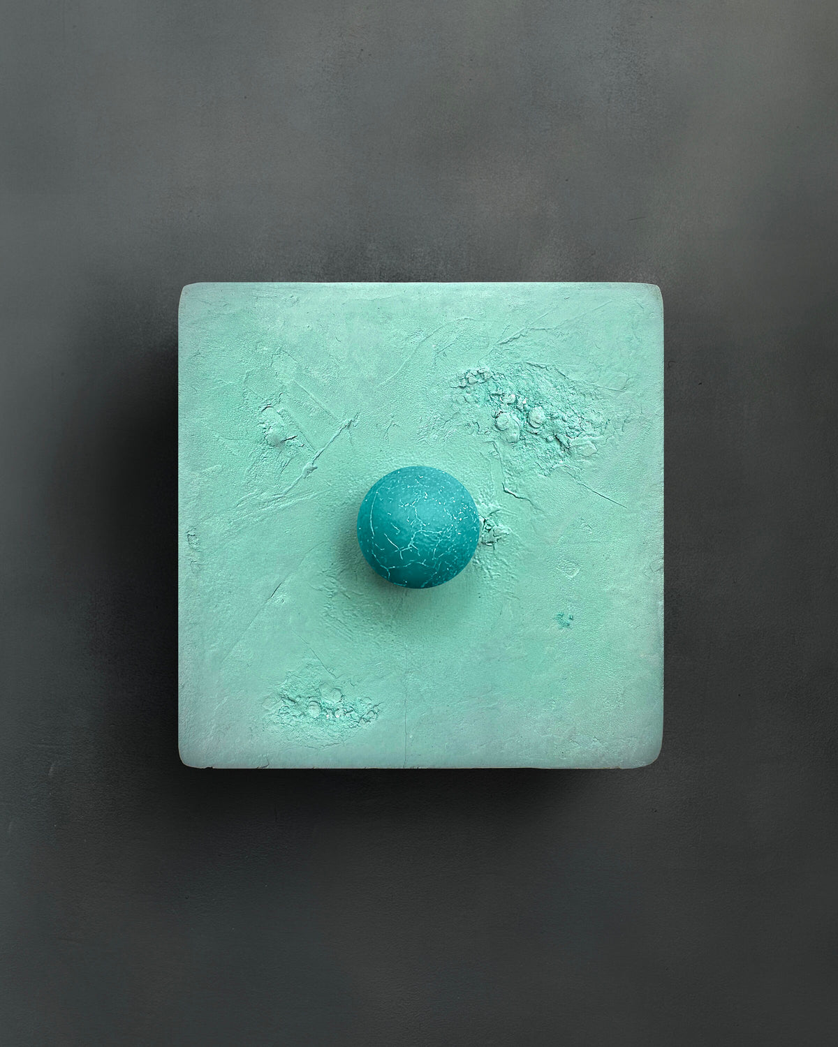 DOT — Mint with teal, mint plaster square with teal sphere on dark wall