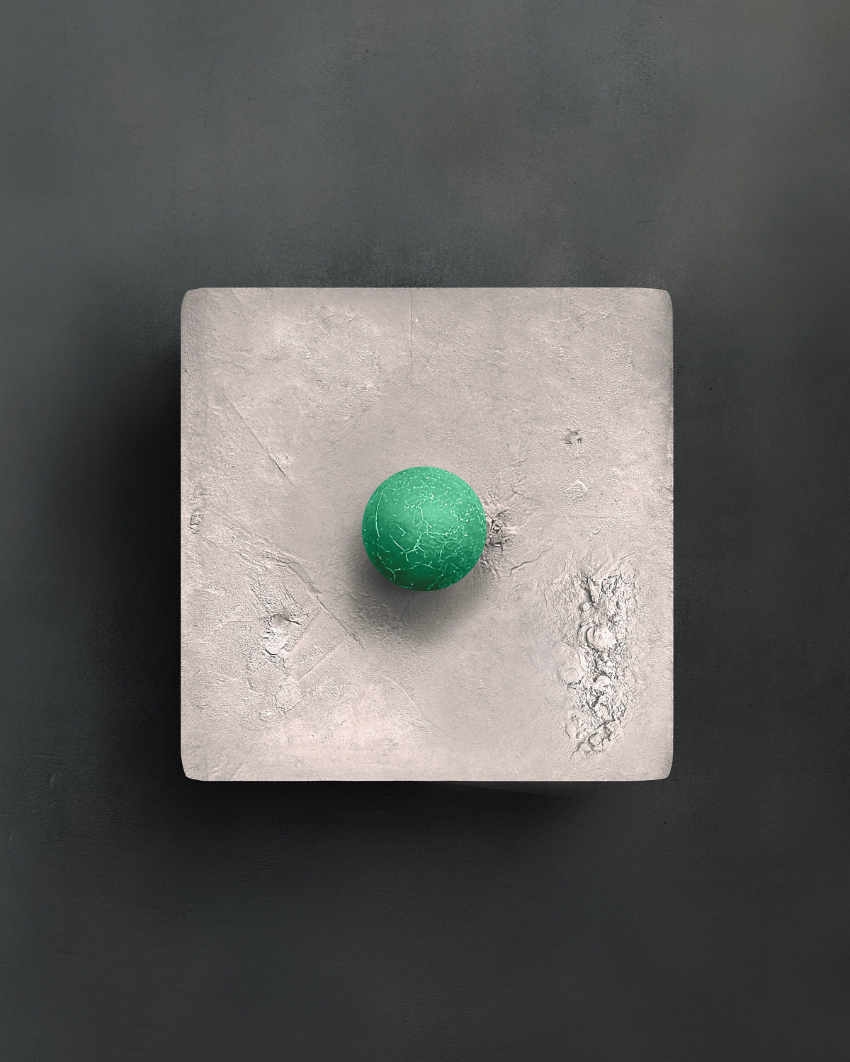 DOT — Gray with green, pale gray square with green sphere on dark wall