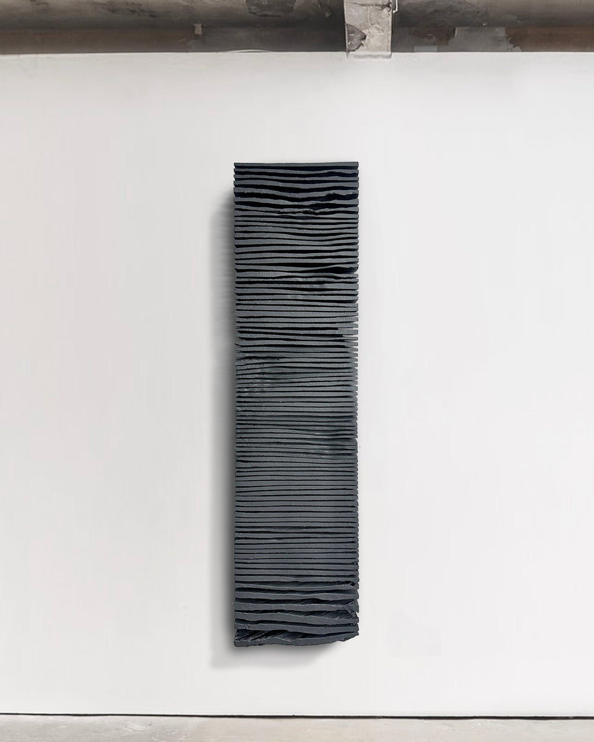 SHADOW — Noir Midnight, close-up surface detail, hand-cut ridges in mineral black plaster