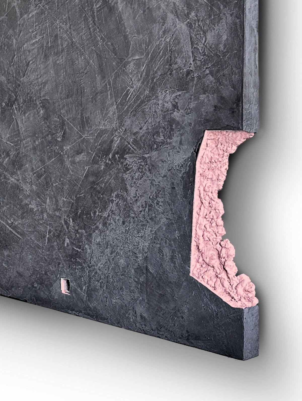 AUSTERE NAUGHTY — edge detail, eroded pink plaster revealed in a cut corner