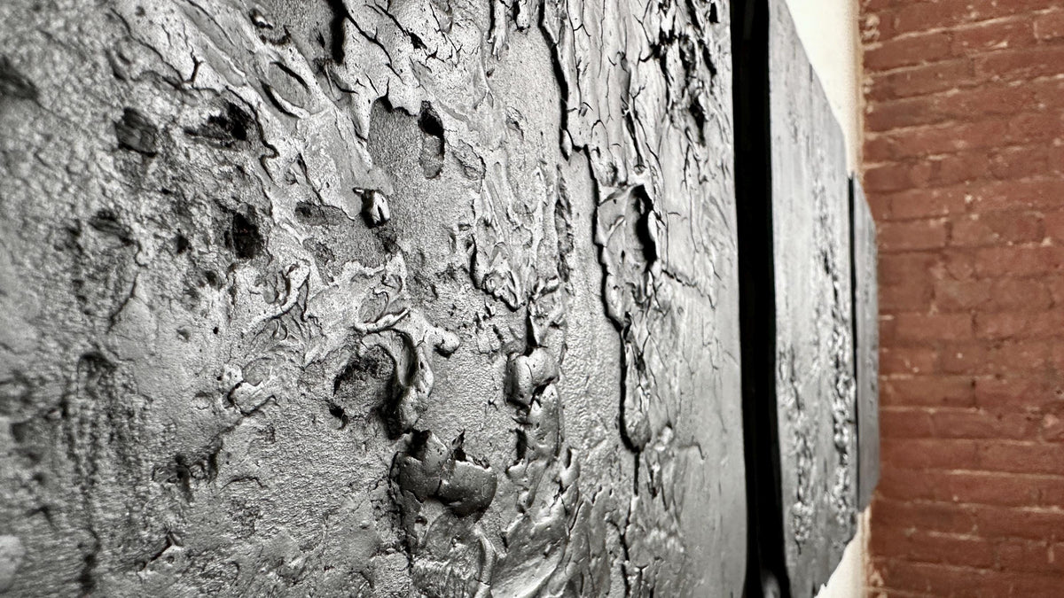 STRATUM — Charcoal Black, close-up of cracked and lifted plaster surface